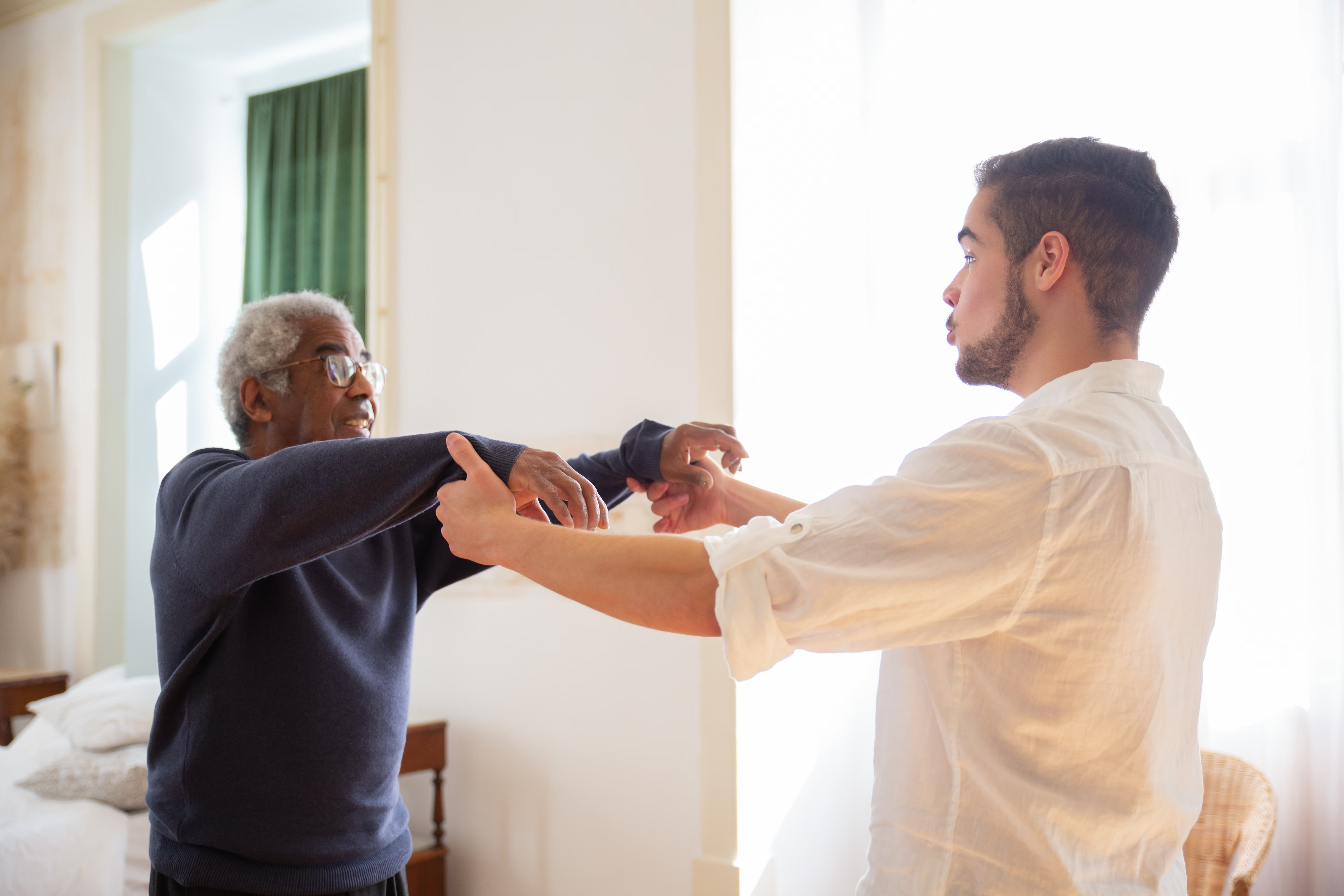 Physiotherapist helping a patient improve movement at home in Emirates